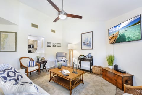 Living Room and Kitchen Pass-Through – Harbour Oaks 316 - Another angle of the Harbour Oaks 316 living room, with soaring ceilings, streaming TV, and a kitchen pass-through for easy entertaining on St. Simons Island.