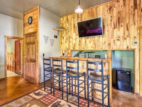 Bar area with Smart TV and mini fridge.