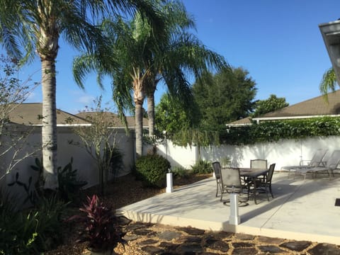 Huge rear patio with dining table for six and lounge chairs