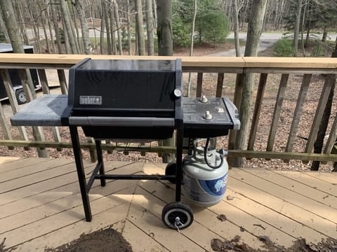 Weber Propane Grill on wood side deck.