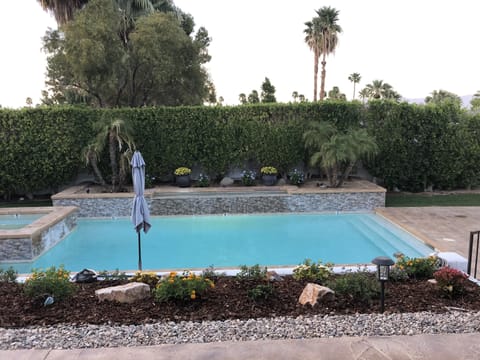 Large Turquoise blue pool and spa with water feature