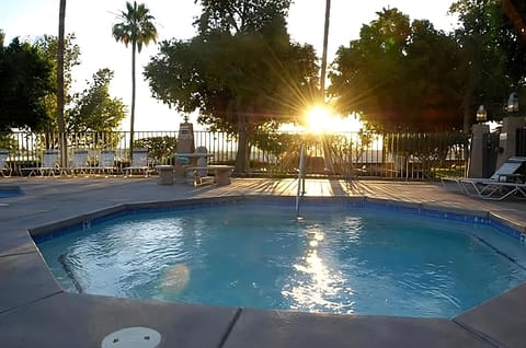 Unwind in the sparkling pool as sunset lights the water.