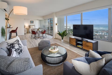 Large, spacious living / dining area - with yacht harbor and pacific ocean views behind TV!