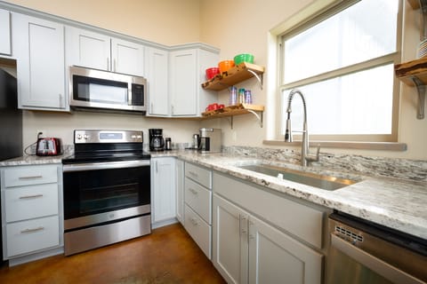 Fully stocked kitchen with keurig, coffee pot, and electric kettle. 