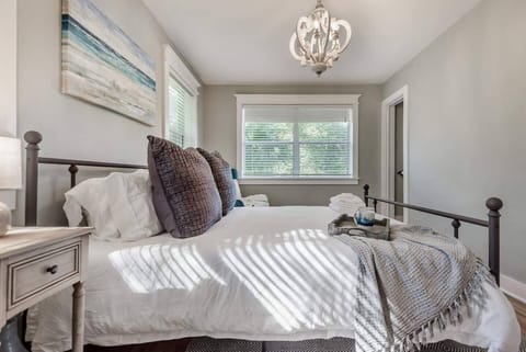 Charming Bedroom: Enjoy sunlit mornings and plush pillows in this serene retreat!