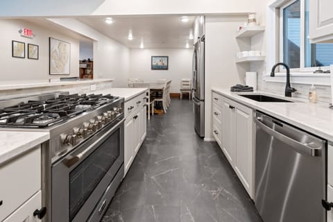 Huge propane oven grill with a huge granite kitchen island and fireplace!