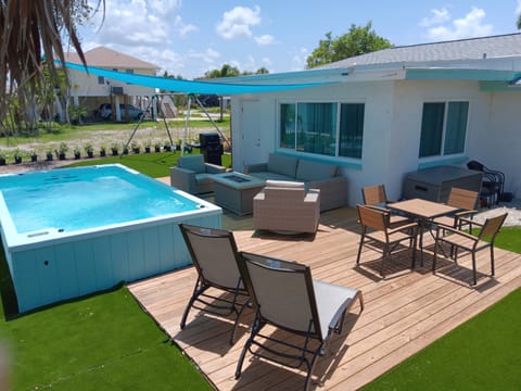 Back yard to relax in and have fun.  Oversized, partially in ground, swim spa.