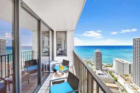 Relax on the balcony with ocean views and comfortable seating.