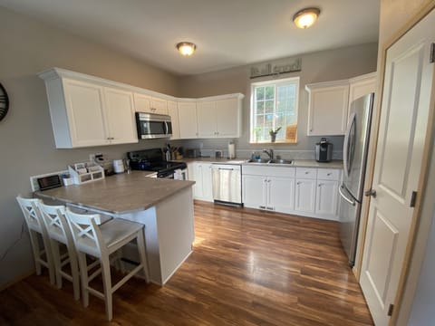 Modern kitchen w/SS appliances,  dishwasher, microwave, and Keurig coffee maker.