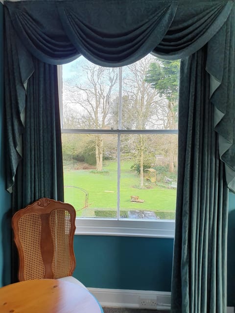 Apartment overlooks the large front garden with stream