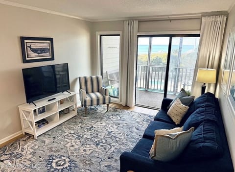Living room with screen porch/balcony and ocean view