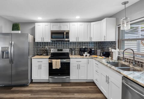 With updated appliances, polished countertops, and elegant cabinetry, this kitchen blends modern aesthetics with everyday functionality.