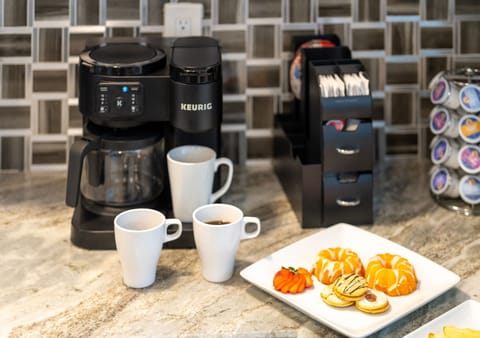 Complete with a dedicated coffee station, this kitchen is a dream for caffeine enthusiasts—stocked with a coffee maker, Keurig, and plenty of mugs.