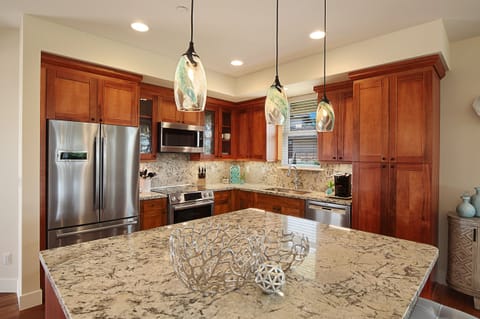 Chef-worthy kitchen with stainless steel appliances, granite countertops, and a spacious breakfast bar for casual mornings or gourmet nights in.