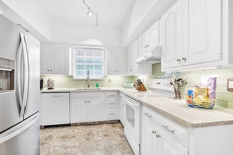 Kitchen with a seafoam color that has every amenity.