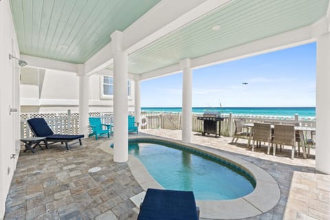Steps from the sand, relax poolside while listening to the waves crash ashore.