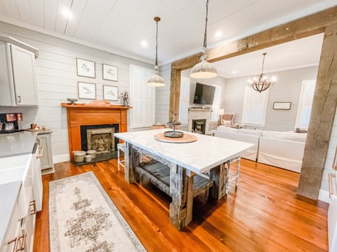 The kitchen features a gorgeous island with a 2" thick marble slab.