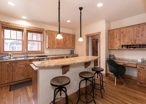 Island with 3 bar stools, built in desk, Jenn-air fridge, double basin sink, Frigidaire dishwasher, 4 gas burner stove with oven, Keurig coffee maker, toaster, blender