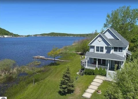 OVERALL:  A nice aerial view of the house with Betsie Lake right next to the house and downtown Frankfort and Lake Michigan in the distance.
