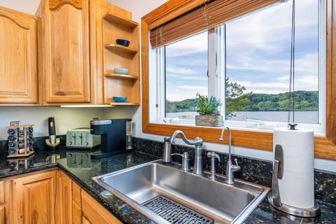 KITCHEN:  The home has a large modern kitchen with all appliances, a large kitchen island with seating, and great views of Betsie Lake!