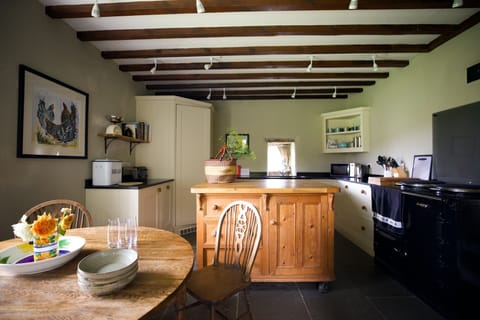 Heatherdene - the farmhouse kitchen with original beams, an electric AGA, and flagstone floor