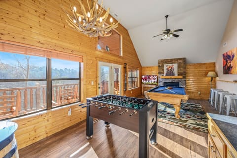 Huge game room with gas fireplace, pool table, arcade game, wet bar & foosball!