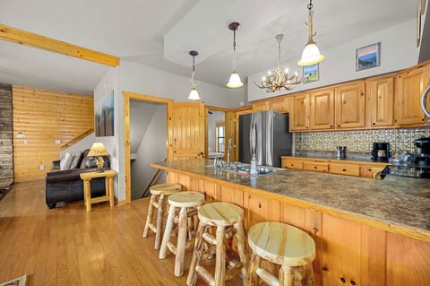 Beautiful custom log wood bar stools for entertaining and easy seating for 12!