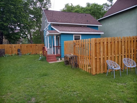 back yard with privacy fencing, patio, and gas grill