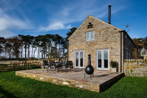 The Granary at Rothley East Shield - outdoor dining area for six guests with wood-burning chiminea