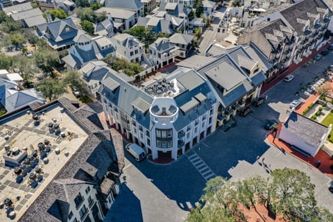 Aerial view showcases the distinctive property architecture and surrounding neighborhood's charming streetscape.