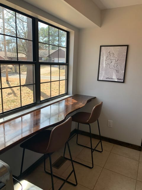 Beautiful live edge breakfast bar looking out into green space.