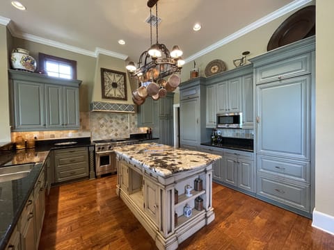Gourmet Kitchen with large walk-in pantry off to side fully stocked.