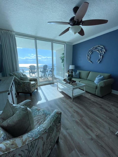 Living room with a sleeping sofa, 65" TV Sliding doors open to the gorgeous view