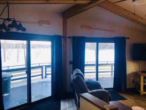 Sliding doors exit to the deck and overlook the lake