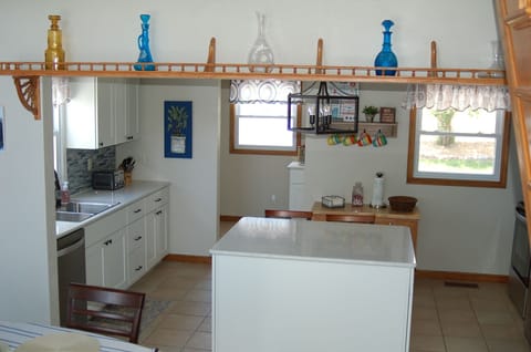 View of kitchen from stairs to upper level
