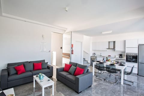 Living room with comfortable sofas, coffee table and Smart TV