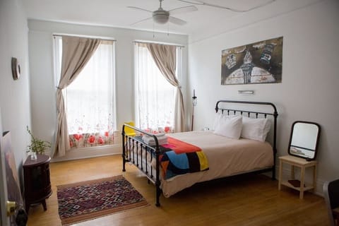 Your Main Street-facing bedroom, outfitted with a queen-size memory foam bed, down pillows and natural fiber linens.