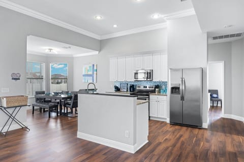 The kitchen is fully equipped with an island for extra space