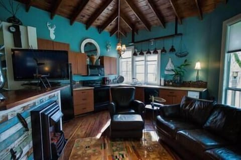Open concept viewing the kitchen area. Electric fireplace, Direct TV, leather sofa. 