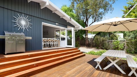 Blue Beachside Retreat Outdoor Entertainment Area with BBQ
