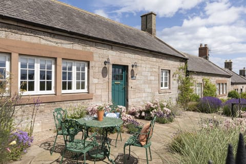 Farm Cottage - front external view of the cottage with patio garden and garden furniture