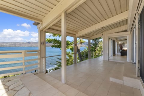 Step out from the primary suite onto a covered lanai where ocean breezes meet sweeping views.