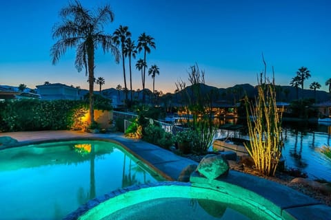 Serene nights by the water—where the pool glows and the palm trees whisper.