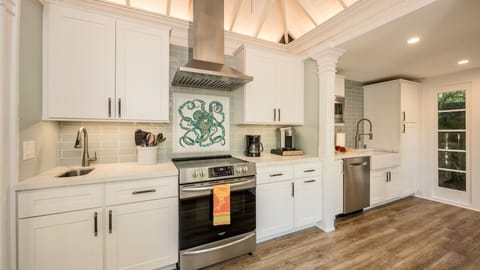 The kitchen features stainless steel appliances...