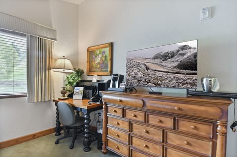Guest bedroom with desk for working guests, Keurig coffee maker and Smart TV