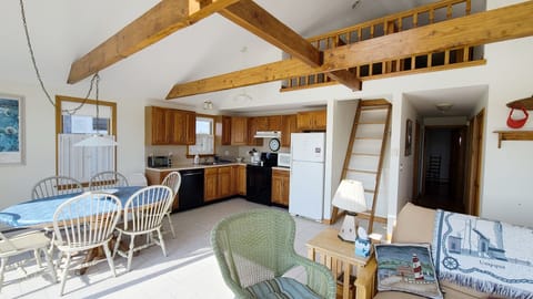 Vaulted ceiling with exposed beams and open loft