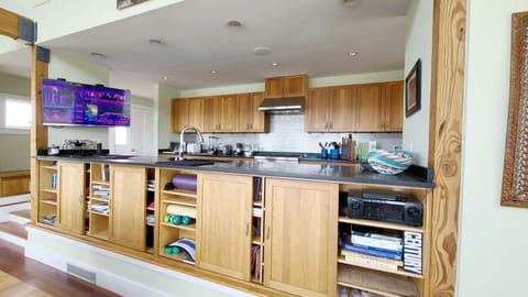 Kitchen looks out over the living room  towards the water