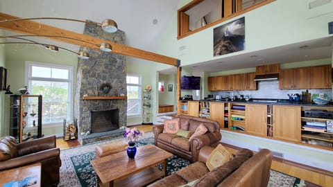 Dining area with living room and open kitchen beyond