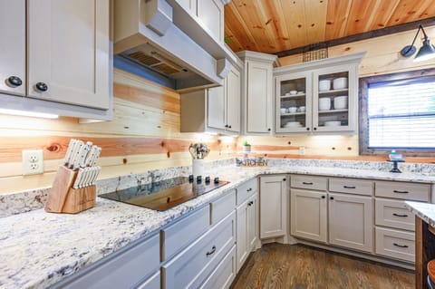 The white cabinets and stone countertops add brightness to the home.