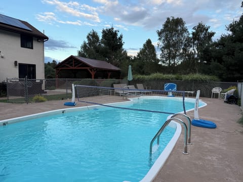 Private pool with basketball hoop and volleyball